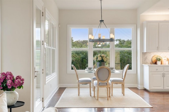 512 Newhall Cv, Austin, TX 78746 - dining area featuring a chandelier, plenty of natural light, wood finished floors, and baseboards