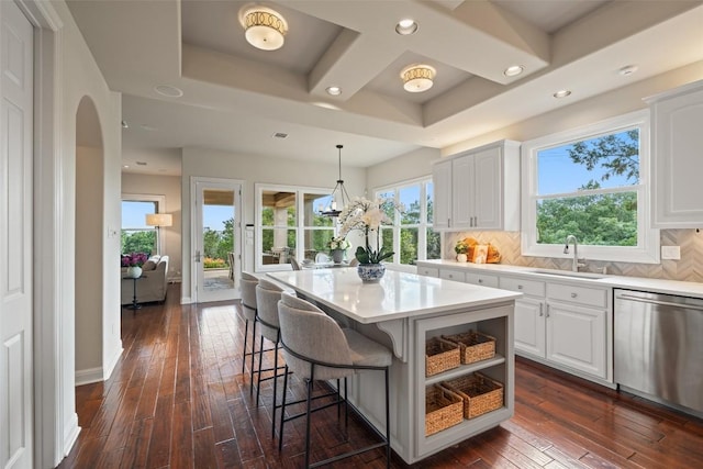 512 Newhall Cv, Austin, TX 78746 - kitchen featuring stainless steel dishwasher, a sink, dark wood finished floors, white cabinetry, and recessed lighting