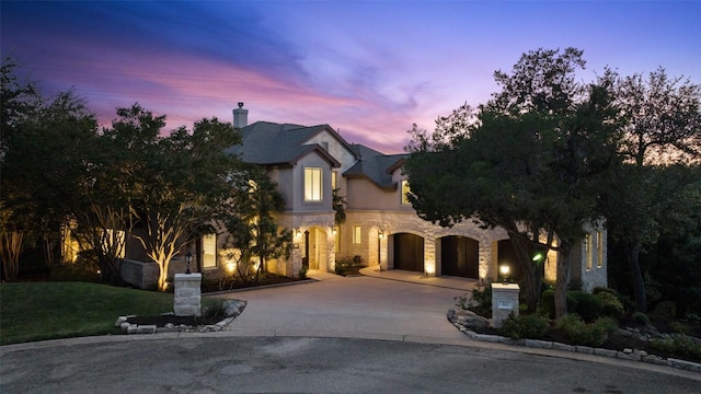 512 Newhall Cv, Austin, TX 78746 - french country inspired facade featuring stone siding and curved driveway