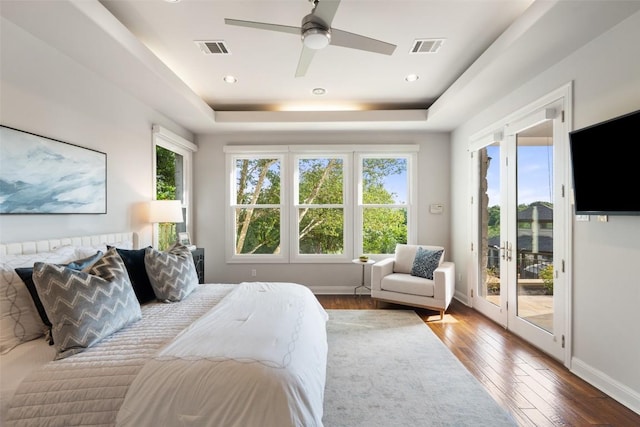 512 Newhall Cv, Austin, TX 78746 - bedroom with access to exterior, hardwood / wood-style floors, a tray ceiling, baseboards, and a ceiling fan
