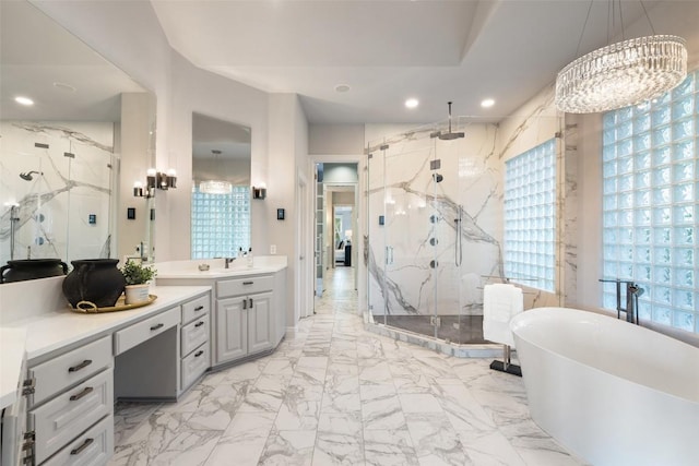 512 Newhall Cv, Austin, TX 78746 - bathroom featuring a marble finish shower, marble look tiles, vanity, a soaking tub, and a chandelier