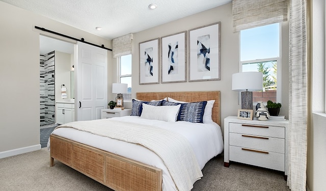 1028 Stonehill Dr, Georgetown, TX 78633 - bedroom featuring carpet flooring, a barn door, and baseboards