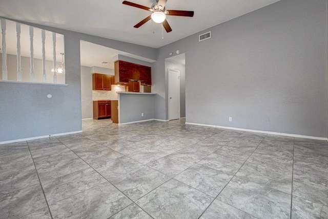 4401 Teri Rd, Austin, TX 78744 - unfurnished living room with a ceiling fan, a textured wall, and baseboards