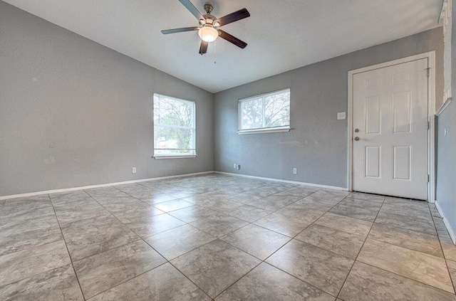4401 Teri Rd, Austin, TX 78744 - unfurnished room featuring lofted ceiling, a ceiling fan, baseboards, and a textured wall