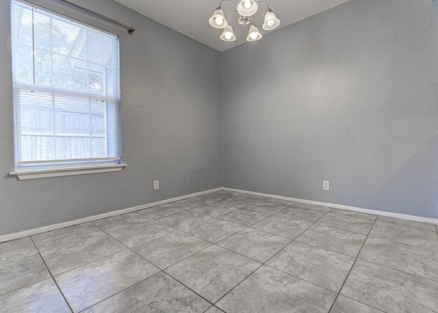 4401 Teri Rd, Austin, TX 78744 - tiled spare room with a chandelier, a textured wall, and baseboards