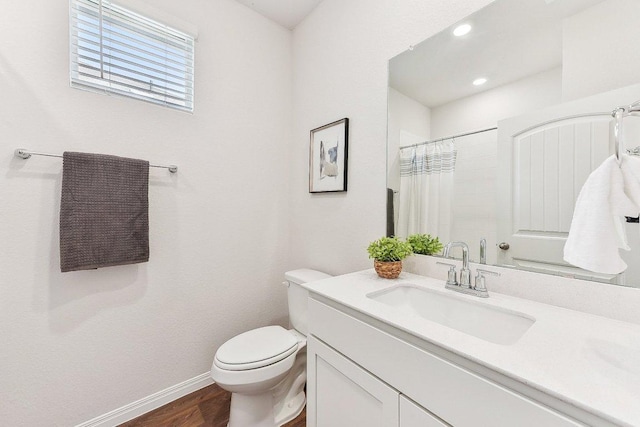 208 Charles Trl, Georgetown, TX 78626 - bathroom featuring toilet, vanity, wood finished floors, baseboards, and curtained shower