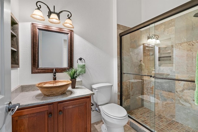 282 Trail Of The Flowers, Georgetown, TX 78633 - bathroom featuring vanity, toilet, a stall shower, and a textured wall