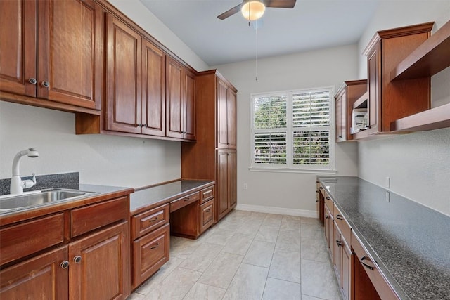 282 Trail Of The Flowers, Georgetown, TX 78633 - kitchen featuring a sink, a ceiling fan, dark countertops, brown cabinetry, and open shelves