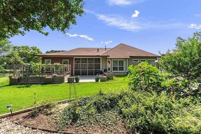 282 Trail Of The Flowers, Georgetown, TX 78633 - rear view of house featuring a garden, a yard, and a sunroom
