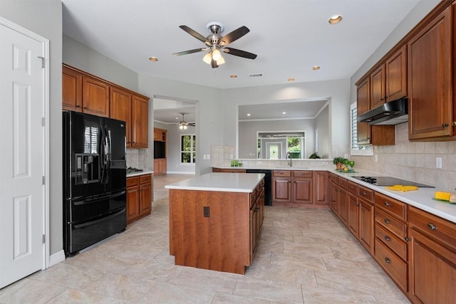 282 Trail Of The Flowers, Georgetown, TX 78633 - kitchen with black appliances, ceiling fan, backsplash, a kitchen island, and light countertops