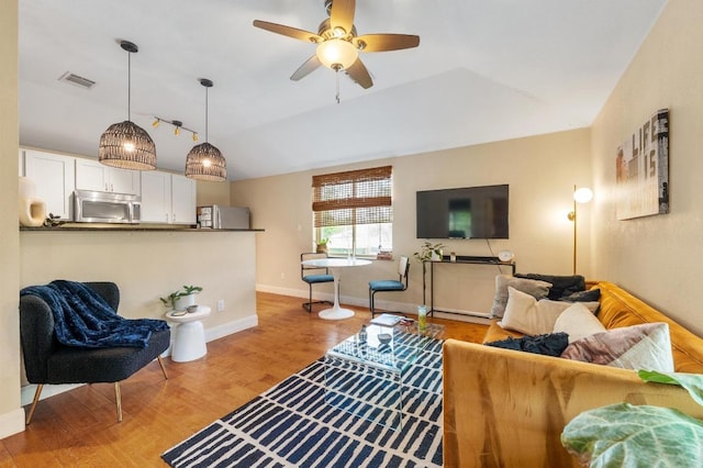 111 Adam L Chapa Sr St, Austin, TX 78702 - living area featuring a ceiling fan, wood finished floors, vaulted ceiling, and baseboards