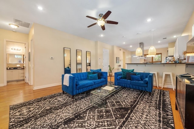 111 Adam L Chapa Sr St, Austin, TX 78702 - living room featuring light wood-style flooring, a ceiling fan, baseboards, and recessed lighting