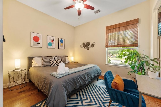 111 Adam L Chapa Sr St, Austin, TX 78702 - bedroom with wood finished floors, baseboards, and ceiling fan