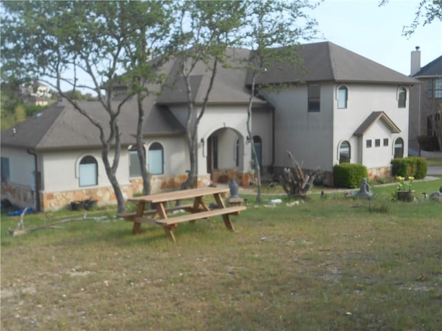 159 Catfish Cv, Dripping Springs, TX 78620 - rear view of house featuring stucco siding and a yard