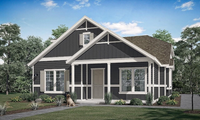 8606 Dongan Dr, Austin, TX 78744 - view of front facade featuring a front lawn, a shingled roof, and covered porch
