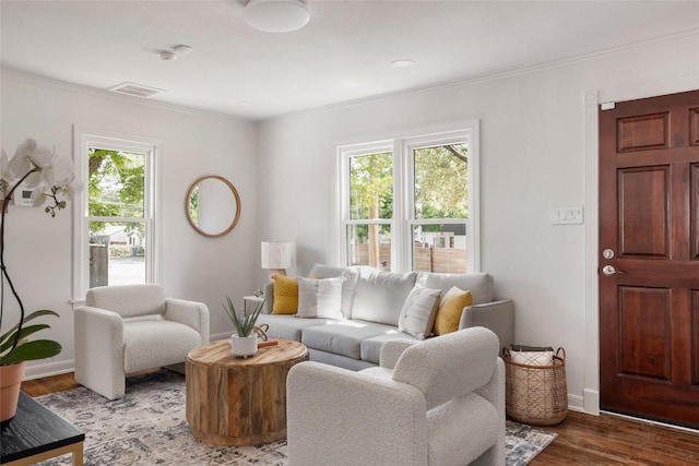 5306 Harmon Ave, Austin, TX 78751 - living area featuring healthy amount of natural light, crown molding, wood finished floors, and baseboards