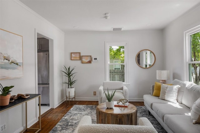 5306 Harmon Ave, Austin, TX 78751 - living area featuring dark wood finished floors, ornamental molding, and baseboards