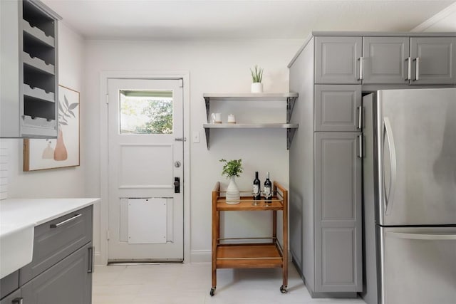 5306 Harmon Ave, Austin, TX 78751 - kitchen with gray cabinets, freestanding refrigerator, and light countertops