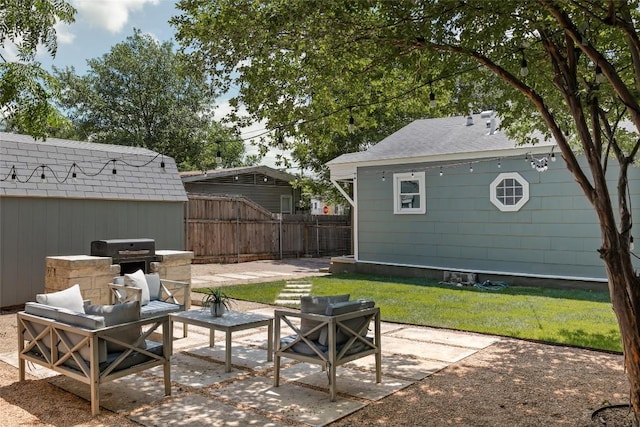 5306 Harmon Ave, Austin, TX 78751 - fenced backyard with a patio, outdoor lounge area, a grill, and an outdoor structure