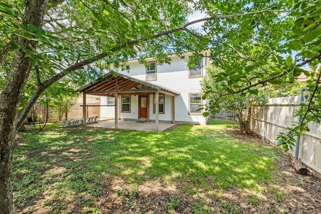 18109 Canopy Ln, Manor, TX 78653 - rear view of house with a patio and stucco siding