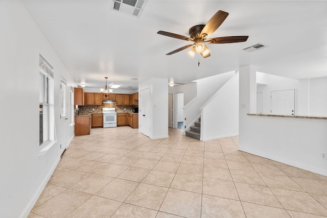 18109 Canopy Ln, Manor, TX 78653 - unfurnished living room featuring light tile patterned floors, a chandelier, stairs, a ceiling fan, and baseboards