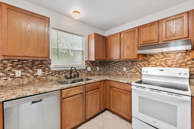 18109 Canopy Ln, Manor, TX 78653 - kitchen featuring electric range, stainless steel dishwasher, under cabinet range hood, a sink, and tasteful backsplash