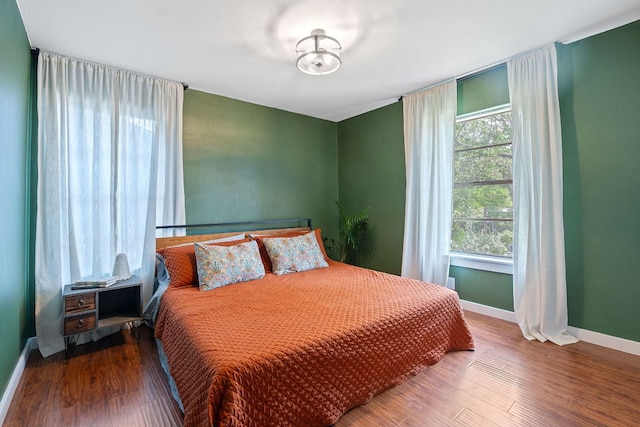 5206 Ledesma Rd, Austin, TX 78721 - bedroom featuring multiple windows, baseboards, and wood finished floors