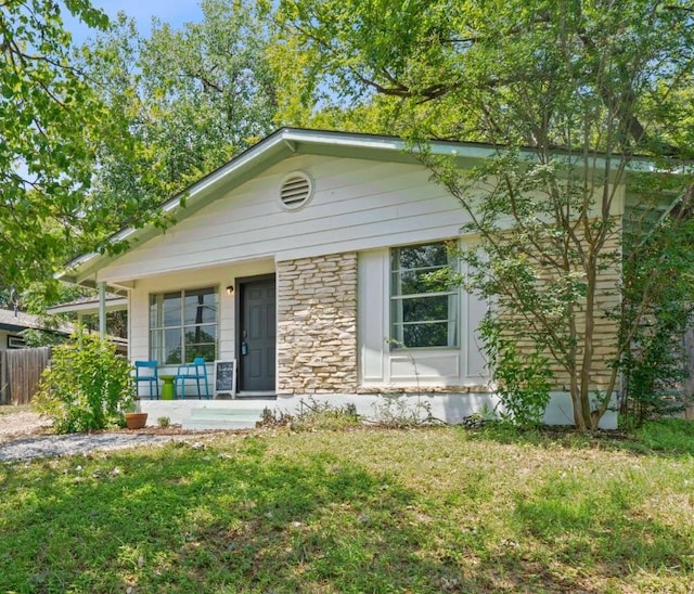 5206 Ledesma Rd, Austin, TX 78721 - ranch-style home featuring a porch and stone siding