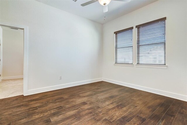 1801 Roseburg Dr Unit 29, Austin, TX 78754 - spare room featuring dark wood-style floors, a ceiling fan, and baseboards