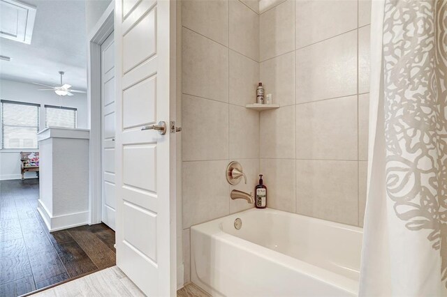 1801 Roseburg Dr Unit 29, Austin, TX 78754 - bathroom with shower / bathtub combination with curtain, wood finished floors, and baseboards