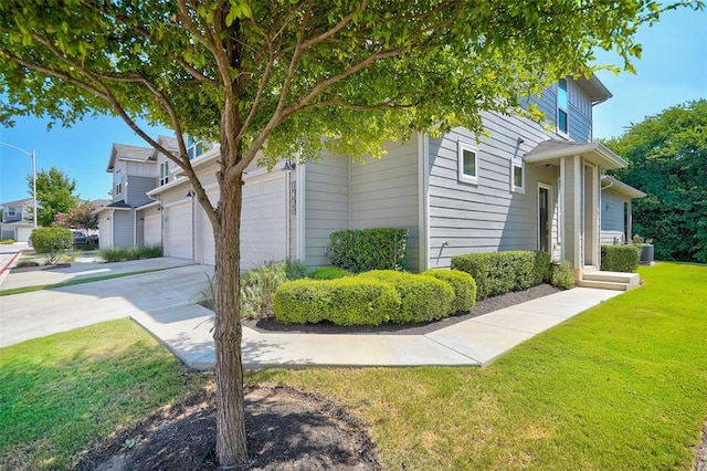 1801 Roseburg Dr Unit 29, Austin, TX 78754 - view of side of property with a yard, driveway, central AC unit, and a garage