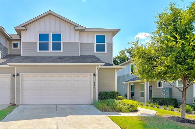 1801 Roseburg Dr Unit 29, Austin, TX 78754 - view of front of property with driveway, board and batten siding, an attached garage, and roof with shingles