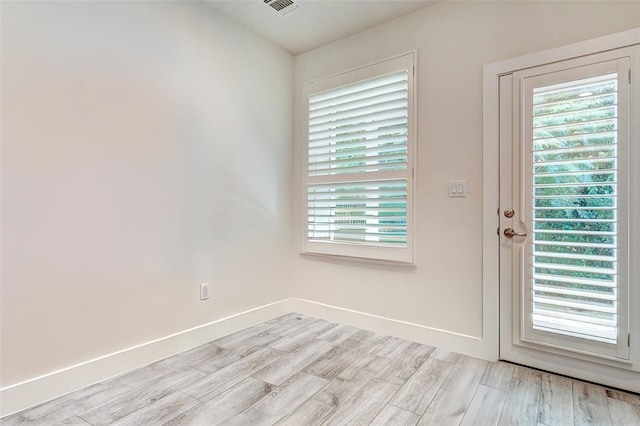 1801 Roseburg Dr Unit 29, Austin, TX 78754 - doorway featuring light wood-type flooring and baseboards