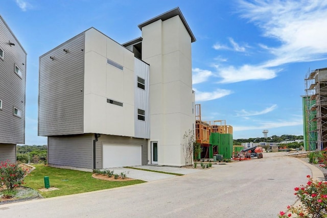 4300 Mansfield Dam Rd Unit 1231, Austin, TX 78734 - view of building exterior with an attached garage and concrete driveway