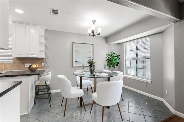 12103 Wycliff Ln, Austin, TX 78727 - dining space featuring tile patterned floors, a chandelier, baseboards, and recessed lighting