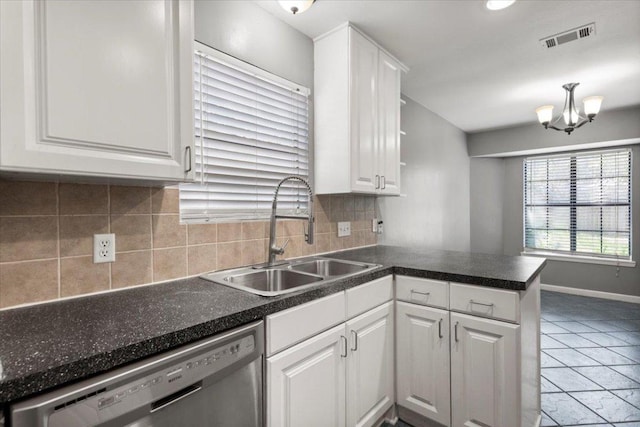 12103 Wycliff Ln, Austin, TX 78727 - kitchen with stainless steel dishwasher, a sink, a peninsula, white cabinets, and backsplash