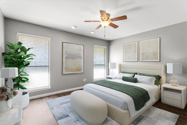 12103 Wycliff Ln, Austin, TX 78727 - bedroom featuring multiple windows, wood finished floors, and baseboards