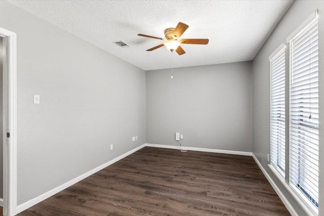 12103 Wycliff Ln, Austin, TX 78727 - unfurnished room with healthy amount of natural light, a ceiling fan, dark wood-style floors, a textured ceiling, and baseboards