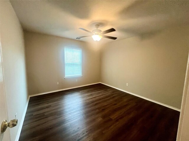 144 Sampson, Kyle, TX 78640 - empty room with dark wood finished floors, baseboards, and ceiling fan