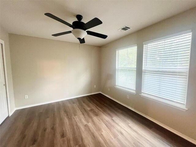 144 Sampson, Kyle, TX 78640 - spare room featuring dark wood-style flooring, baseboards, and ceiling fan