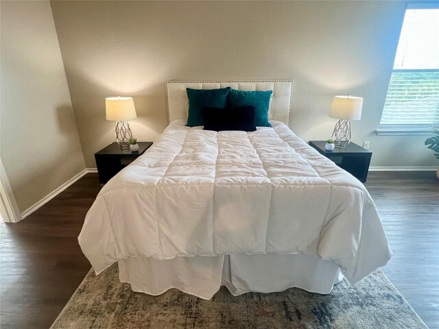 144 Sampson, Kyle, TX 78640 - bedroom with baseboards and dark wood-style floors