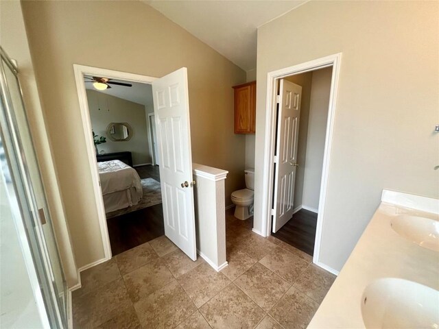 144 Sampson, Kyle, TX 78640 - ensuite bathroom with toilet, lofted ceiling, double vanity, a ceiling fan, and baseboards