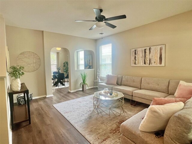 144 Sampson, Kyle, TX 78640 - living area featuring arched walkways, a ceiling fan, dark wood-style floors, and baseboards