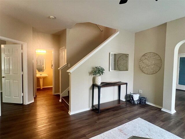 144 Sampson, Kyle, TX 78640 - entryway with stairs, dark wood-style floors, baseboards, ceiling fan, and arched walkways