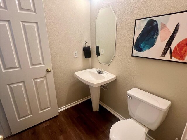 144 Sampson, Kyle, TX 78640 - half bathroom featuring toilet, wood finished floors, and baseboards