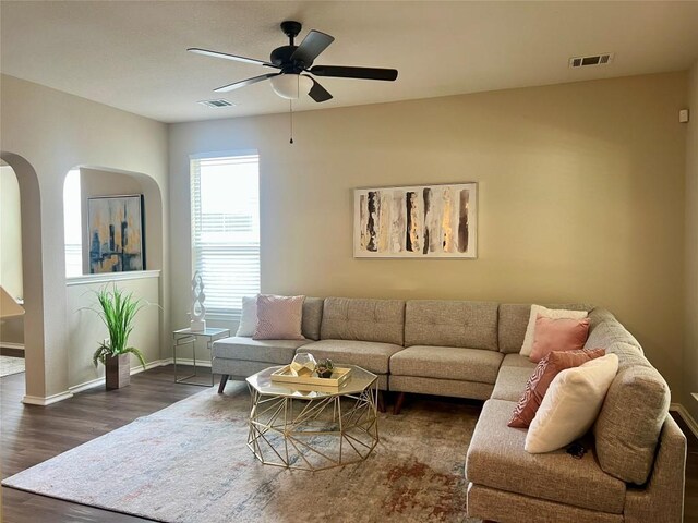 144 Sampson, Kyle, TX 78640 - living area featuring a ceiling fan, dark wood-type flooring, baseboards, and arched walkways
