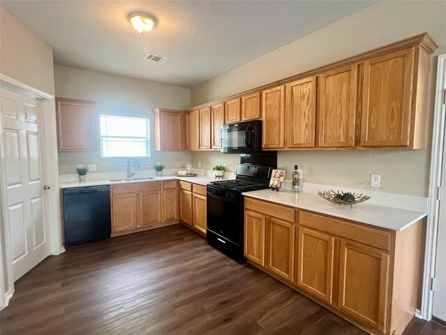 144 Sampson, Kyle, TX 78640 - kitchen featuring black appliances, a sink, dark wood-type flooring, and light countertops