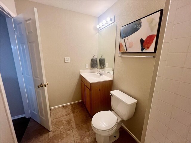 144 Sampson, Kyle, TX 78640 - bathroom featuring vanity, toilet, and tile patterned flooring