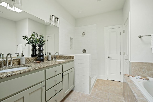 4048 Berkman Dr, Austin, TX 78723 - full bathroom featuring double vanity, a garden tub, a tile shower, and tile patterned floors