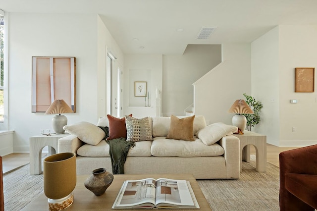 4048 Berkman Dr, Austin, TX 78723 - living area featuring stairway, baseboards, and light wood-style flooring